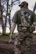 British soldier holding a drone and rifle. Wearing a Mora SUAS drone T-Shirt.