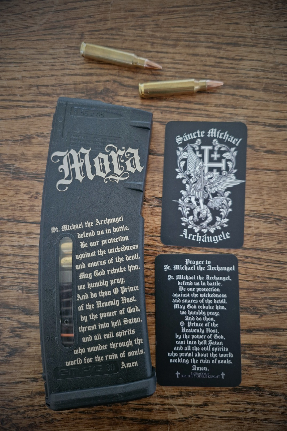 Saint Michael prayer card double sides next to a St Michael prayer engraved 5.56 Emag.